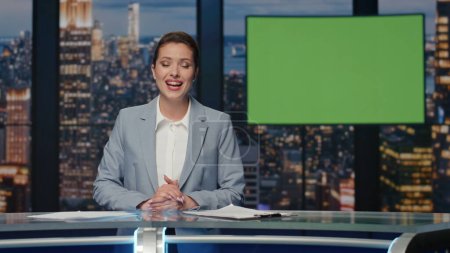 Photo for Positive news presenter talking evening chromakey tv channel studio closeup. Anchor woman broadcasting greenscreen display. Beautiful announcer taking folder ending mockup screen broadcast background - Royalty Free Image