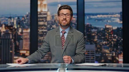 Photo for Elegant newscaster presenting daily breaking news in evening television show closeup. Bearded professional presenter reading script broadcasting newscast. Confident man reporting about business event - Royalty Free Image