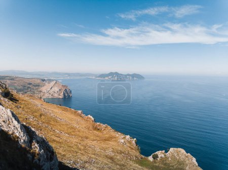 Photo for Landscape of the Cantabrian coast with the cliffs of Mount Candina and Laredo in the background. In Cantabria, a sunny summer day. - Royalty Free Image