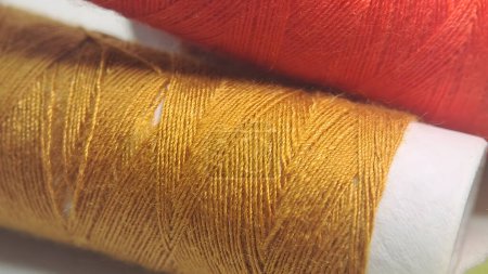 Photo for Two spools of thread with orange and yellow colors - Royalty Free Image