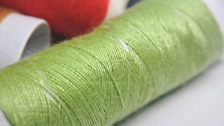 Photo for A spool of thread with green and red colors - Royalty Free Image