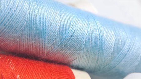Photo for A spool of thread with blue and red colors - Royalty Free Image