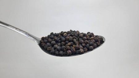 Photo for Dry black pepper seeds on a spoon - Royalty Free Image
