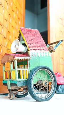 A colorful wooden wagon styled like a traditional Betawi tribal house equipped with a loudspeaker. This wagon is one of the traditional Betawi complements in Indonesia.