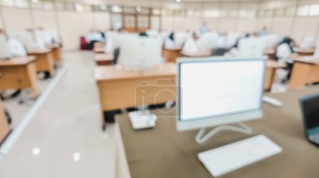 Blurred image of amount of civil servants working on a computer-based competency test in the Computer Classroom. Learning management system concept