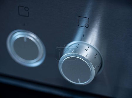 Photo for Kitchen oven, close-up rotary switch to choose a program for the baking oven. Stove in brushed metallic. - Royalty Free Image