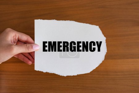 Emergency. Woman hand holds a piece of paper with a note, emergency. First care, incident, first aid, urgency, help, treatment.