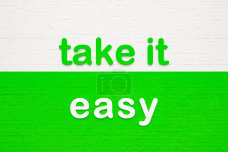 Take it easy. Colored letters against a white and green brick wall. Advice, motto, cool attitutde, no worries. 3D illustration