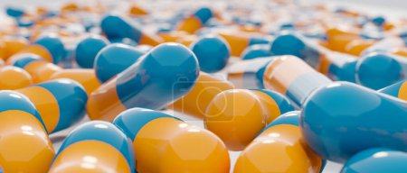 Close-up blue orange medical capsules, pills, antibiotics.Industrial production of medicine, antibiotics or other drugs.