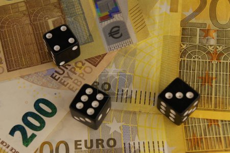 Casino and gambling. Three dice on new 200 euro banknotes.