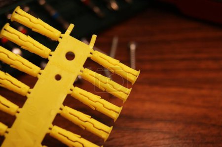 Close-up of yellow plastic dowels. Installation and construction.