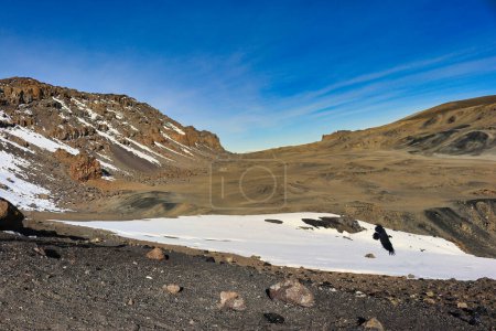 Photo for A view of the Kilimanjaro crater depression from the Kibo crater rim showing temporary snow deposits, Tanzania - Royalty Free Image