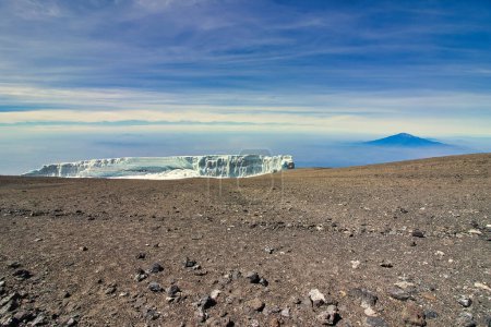 Photo for Rebmann glacier with backdrop of Mount Meru in the early morning light viewed from Kibo crater rim on Kilimanjaro, Tanzania - Royalty Free Image