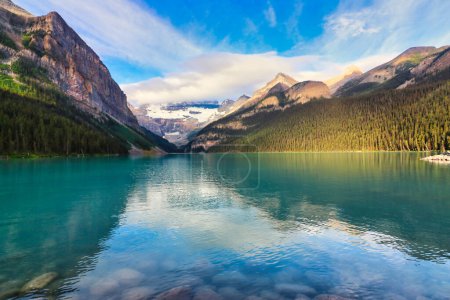 Photo for The Iconic  world famous  picture perfect Lake Louise is framed in the early morning sun near Banff in the Canada rockies - Royalty Free Image