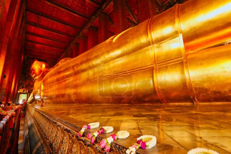 Photo for Wat Pho Reclining Golden Buddha or Wat Phra Chetuphon Wimon Mangkhalaram Rajwaramahawihan Buddha statue at the Historic city center in Bangkok, Thailand - Royalty Free Image