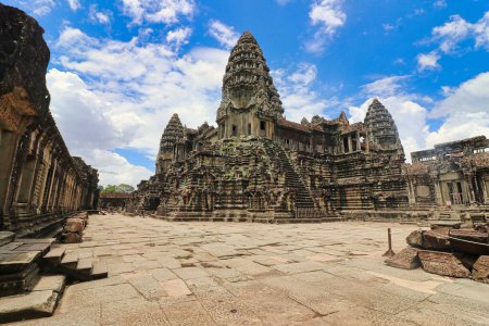 Photo for Angkor Wat Temple Inner Pyramid Complex, masterpiece of Khmer Architecture built in 12th century by Suryavarman II against a bright blue sky at Siem Reap, Cambodia, Asia - Royalty Free Image