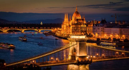 Spectacular view of the Danube river with the Chain bridge and Margit bridge fully lit up along with the historic Hungary Parliament building on the Danube in Budapest, Hungary