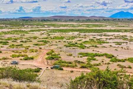 Sweeping panoramic vistas of the semi-arid savanna plains of the Amboseli national park from the top of the Amboseli Hill viewpoint, Kenya