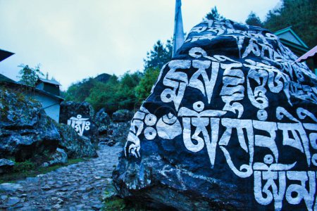 Buddhist Mantra - Om Mani Padme Hum is painted on the rocks along the trekking route to the Everest Base camp from Lukla to Namche Bazaar,Nepal