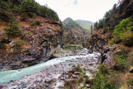 Fast moving rapids of the Dudh Kosi river originating from the Khumbu and Cho Oyu glaciers seen here in a scenic valley setting on the Everest Base Camp trek in lower Namche Bazaar,Nepal