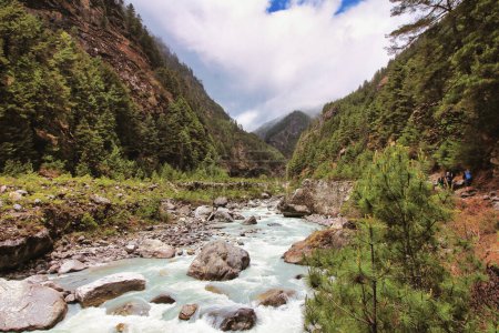 Fast moving rapids of the Dudh Kosi river originating from the Khumbu and Cho Oyu glaciers seen here in a scenic valley setting on the Everest Base Camp trek in lower Namche Bazaar,Nepal