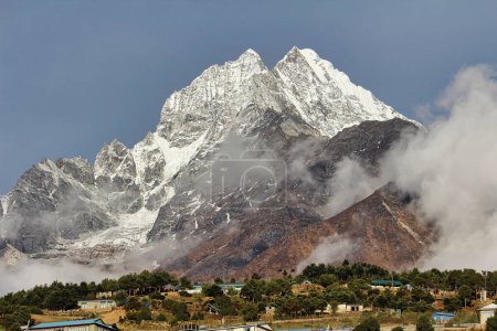 Thamserku twin peaks at 6608 meters shine bright in the morning sun, presenting a magnificent view as it towers above the sherpa market town of Namche Bazaar in the high Himalayas of Khumbu, Nepal
