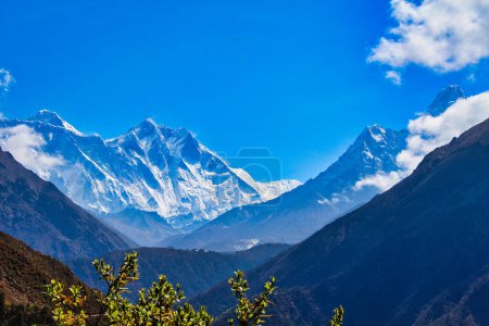 Magnificent view of the Everest Massif and Ama Dablam set against a blue sky behind deep valleys during the Everest Base camp trek near Namche Bazaar, Nepal
