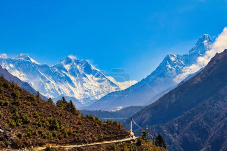 Spectacular scenery of Mount Everest, Lhotse and Ama Dablam set against a blue sky with the Tenzing Chorten memorial in foreground during the Everest Base camp trek near Namche Bazaar, Nepal