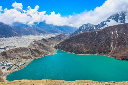 Photo for Gokyo Tsho or Dudh Pokhari is an emerald green high altitude Himalayan lake at 4700 meters,listed as a Ramsar wetland on the shores of Gokyo bordering the vast Ngozumpa glacier in Nepal - Royalty Free Image
