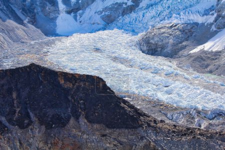 Photo for Everest Base Camp climbers and expedition tents and the base of the Khumbu icefall seen from the top of Kala Pathar on the Khumbu glacier in preparation for climbing Everest in Khumbu, Nepal - Royalty Free Image