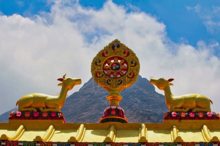Twin deers symbolizing the skillful means and wisdom principles of Buddhist belief along with the Dhamma chakra on top of Tengboche Monastery in Nepal