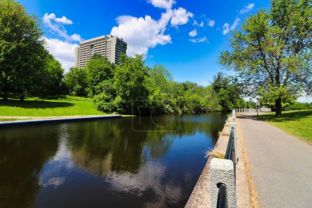 Photo for Rideau Canal runs through the heart of Ottawa with walkways,cycling and walking paths seen here on a brilliant summer day with bright blue skies and calm waters in Ottawa,Ontario,Canada - Royalty Free Image