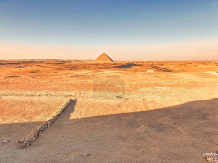 Photo for Magnificent view of the Red Pyramid of Snefuru in an other wordly martian-like desert scene as viewed from the entrance to the Bent Pyramid at the Dahshur necropolis near Cairo,Egypt - Royalty Free Image