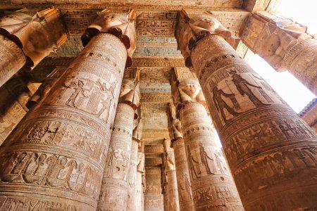 Photo for Magnificent hypostyle columns topped by faces of Hathor and vibrant ceiling art in the Temple of Hathor at Dendera completed in the Ptolemaic era around 50 BC between Luxor and Abydos towns,Egypt - Royalty Free Image