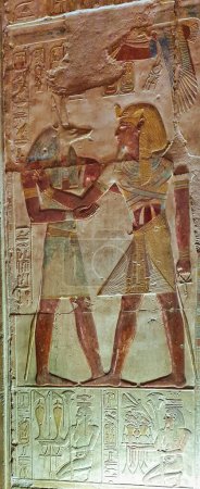Photo for Painted wall relief of Pharaoh Seti I receiving the mummification god Anubis  in the Temple of Seti built in 13th century BC by the Pharoah Seti I near Abydos,Egypt - Royalty Free Image