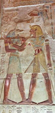 Photo for Painted wall relief of Pharaoh Seti I receiving the mummification god Anubis  in the Temple of Seti built in 13th century BC by the Pharoah Seti I near Abydos,Egypt - Royalty Free Image