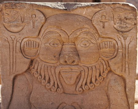 Detallado tallado en piedra del Dios egipcio Bes, protector de los hogares en el patio del Templo de Isis en la isla de Philae en el lago Nasser, construido por Nectanebo y Ptolomeo Faraones cerca de Asuán, Egipto