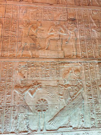 Wall reliefs depicting Pharoah Ptolemy VI making offering to Osiris and Isis on top and Nepthys in the bottom panel the Temple of Isis at Philae Island built by the Ptolemy Pharoahs near Aswan,Egypt