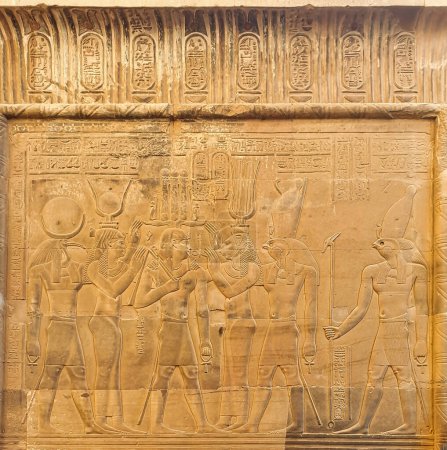 Beautiful wall reliefof Ptolemy XII Neos Dionysos receiving the Breath of Life from Bastet with Thoth,Hathor,Horus and Haroeris at the Temple of Sobek and Haroeris in Kom Ombo,Near Aswan,Egypt