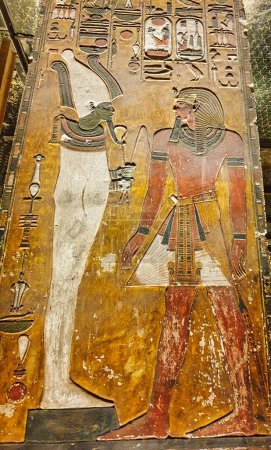 Painted wall relief in Burial chamber J showing Pharoah Seti I before the God Osiris on a pillar in the Tomb of Seti I, KV17 at the Theban necropolis in the Valley of Kings in Luxor,Egypt
