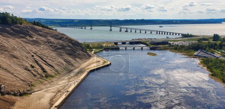 Panoramic view of Saint Lawrence river from the top of the Montmorency Falls with a view of the  Pont de Ille bridge on a bright summer day near Quebec city, the capital of Quebec province,Canada