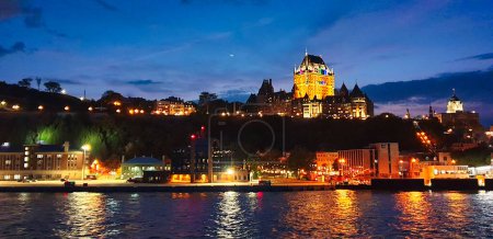 Historic Hotel Fairmont Chateau Frontenac  with its glittering lights in this night time view of the magnificent Quebec city skyline from the ferry on St. Lawrence river  in Quebec city,Canada