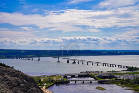 Magnificent wide angle panorama of the St.Lawrence river, the Pont de Ille bridge on a bright summer day taken from the top of the 83m high Montmorency Waterfalls near Quebec city,Canada
