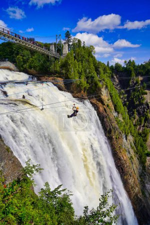 A thrill seeker on a zipline rushes across the thundering waters of the Montmorency Falls near Quebec city, the capital of Quebec province,Canada