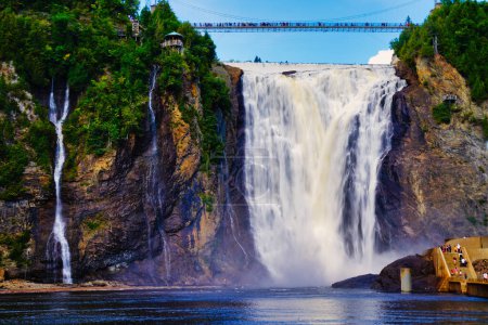 Spectacular view of the Montmorency Falls and the suspension bridge on a bright summer day with blue skies near Quebec city, the capital of Quebec province,Canada
