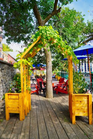 Photo for A quiet leafy cafe to enjoy a break from shopping in the Petit Champlain district in Quebec city, the capital of Quebec province,Canada - Royalty Free Image