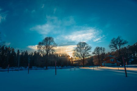 Photo for Gauja, swimming place covered with snow and ice in winter. Sunset. - Royalty Free Image