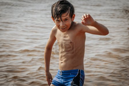 Foto de Niño haciendo ejercicio junto al mar, vacaciones de verano. Enfoque selectivo suave. - Imagen libre de derechos