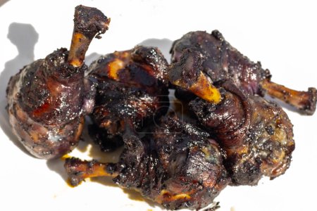 Photo for Charcoal grilled chicken drumsticks marinated in blueberries. Soft selective focus. - Royalty Free Image