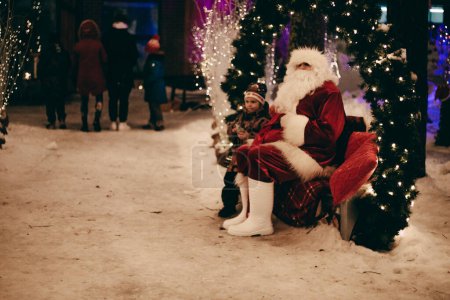 Photo for A cheerful family celebrates the holiday season with Christmas decorations and Santa Claus. Atmospheric distortion, hot air distortion, heat distortion, air refraction - Royalty Free Image